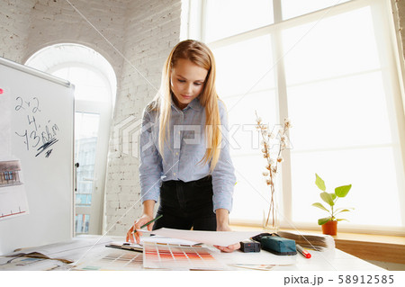 Interior designer working with colour palette in modern office 58912585