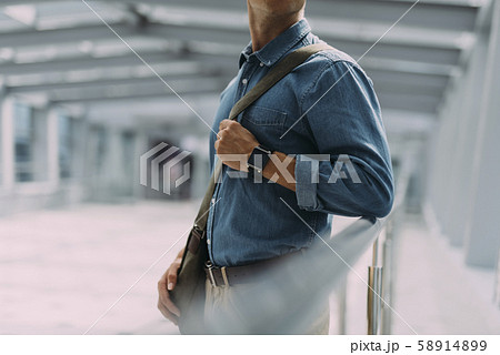 Man with handbag at airport stock photo Man with handbag at airport stock photo 58914899