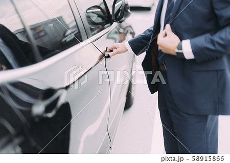 Man in suit getting into car stock photo 58915866