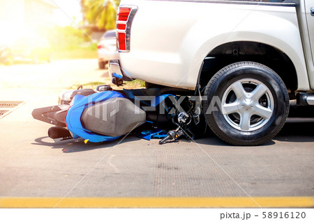 Motorcycle and car accident on a highway, 58916120