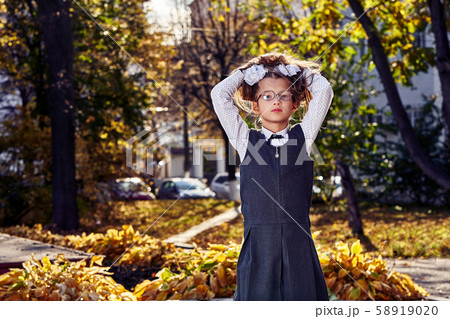 Girl teenager schoolgirl in a school uniform walks 58919020