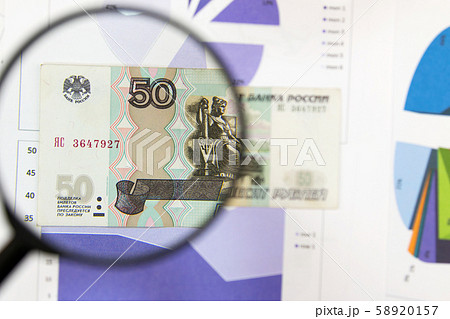 Magnifying glass and money - business background. Magnifying glass and money - business background. 58920157