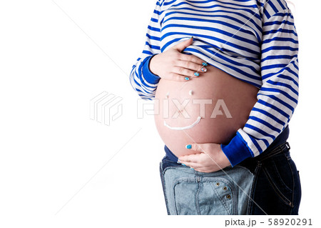 Pregnant woman writing 'smiley' word on her belly. Isolate. Pregnant woman writing 'smiley' word on her belly. Isolate. 58920291