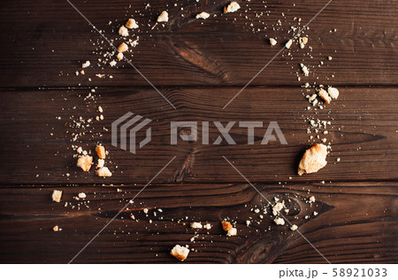 Crumbs from chocolate cookies on a wooden table 58921033