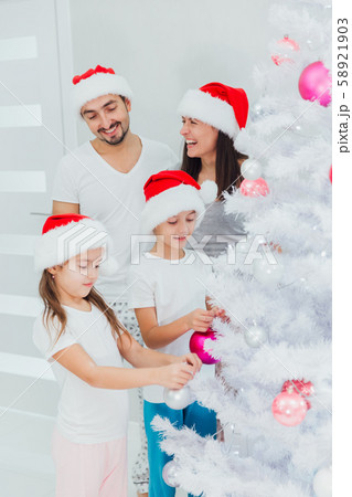 Family members preparing for Christmas together at home Family members preparing for Christmas together at home 58921903