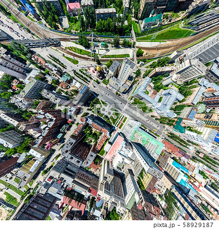Aerial city view with crossroads and roads, houses, buildings, parks and parking lots. Sunny summer Aerial city view with crossroads and roads, houses, buildings, parks and parking lots. Sunny summer 58929187