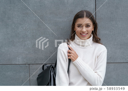Smiling woman deciding to go for a walk alone Smiling woman deciding to go for a walk alone 58933549