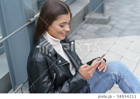Cheerful woman receiving messages from her friends 58934211