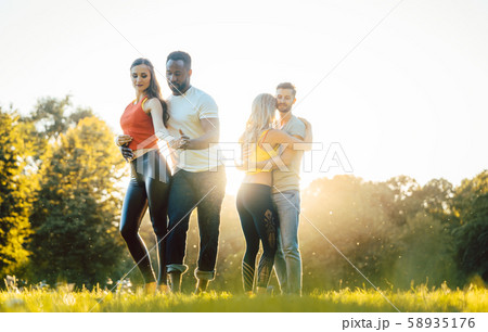 Women and men having fun dancing in the park 58935176