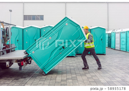 Rental lavatory being loaded on truck 58935178