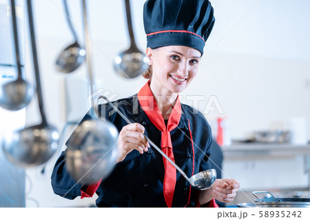 Chef using a metal ladle Chef using a metal ladle 58935242
