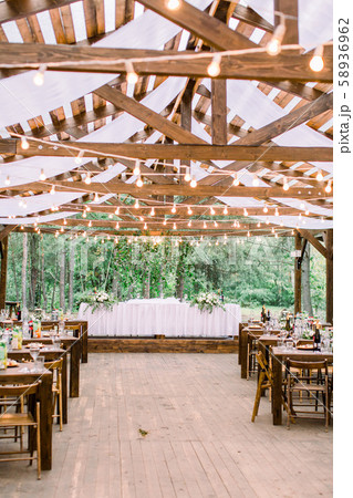 Wedding tables in restaurant outdoors. Banquet. The chairs and table for guests, decorated with Wedding tables in restaurant outdoors. Banquet. The chairs and table for guests, decorated with 58936962