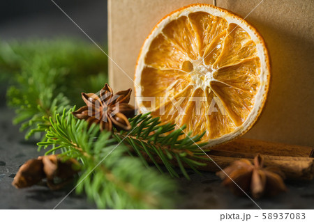 closeup of natural christmas decorations next to brown paper box closeup of natural christmas decorations next to brown paper box 58937083