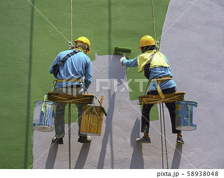 Painters painting exterior of building 58938048