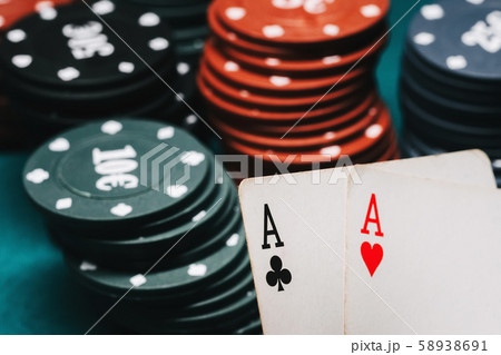 One pair of aces and playing chips in a game of poker One pair of aces and playing chips in a game of poker 58938691