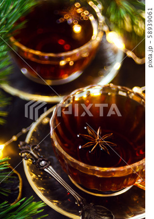 Couple cups of hot spicy tea with anise and cinnamon, selective focus 58939061