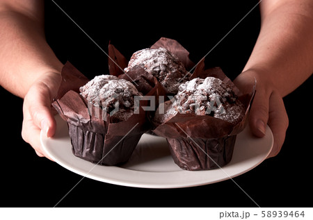 Still life with chocolate muffin with sugar. Woman Still life with chocolate muffin with sugar. Woman 58939464