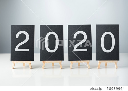 happy new year 2020 with blackboard on white table happy new year 2020 with blackboard on white table 58939964