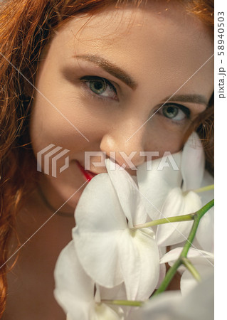 woman with orchids 58940503