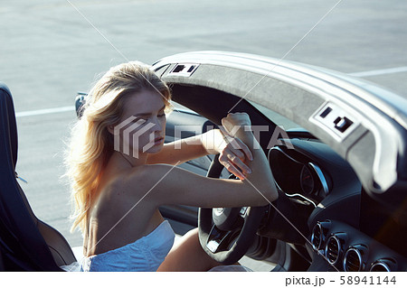 Fashion portrait of dreamy woman in the luxury car. No retouch. 58941144