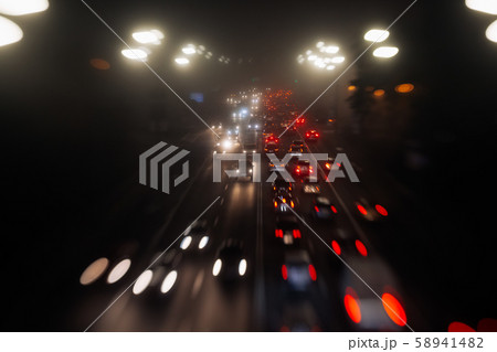 Busy traffic in city fog blur lights of cars on road 58941482