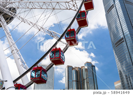Hong Kong -July 16, 2019: International Finance Center(IFC) and Ferris wheel in Hong Kong. IFC mall is one of Hong Kong's most visually appealing shopping destinations. Hong Kong -July 16, 2019: International Finance Center(IFC) and Ferris wheel in Hong Kong. IFC mall is one of Hong Kong's most visually appealing shopping destinations. 58941649