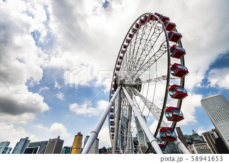 The modern city on the ocean coast. Ferris wheel and skyscraper The modern city on the ocean coast. Ferris wheel and skyscraper 58941653
