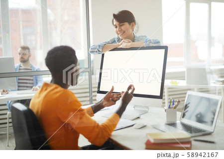 Smiling Colleagues Chatting in Office Smiling Colleagues Chatting in Office 58942167