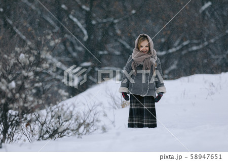 cute little girl in the woods in winter. snowing 58947651