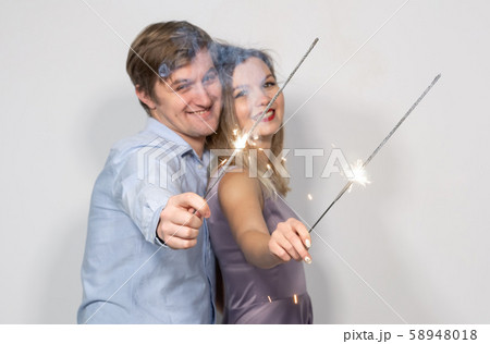 Holidays, new year, christmas and celebrations concept - young couple hugging with crossed bengals 58948018