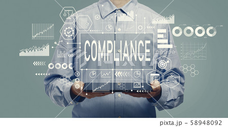 Compliance concept with man holding a tablet 58948092