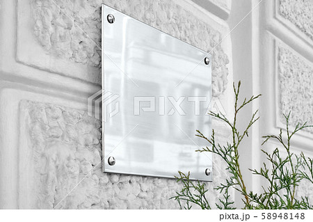 Blank silver glass signboard on gray textured wall mock up 58948148