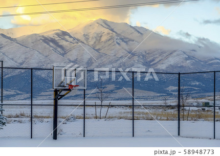 Basketball court and mountain covered with snow Basketball court and mountain covered with snow 58948773