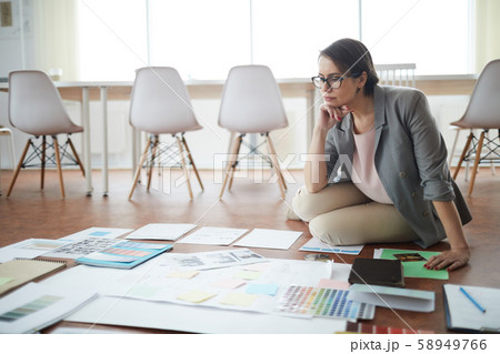 Pensive Businesswoman Sitting on Floor 58949766