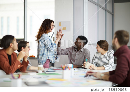 Creative Team High-Five in Meeting 58950068