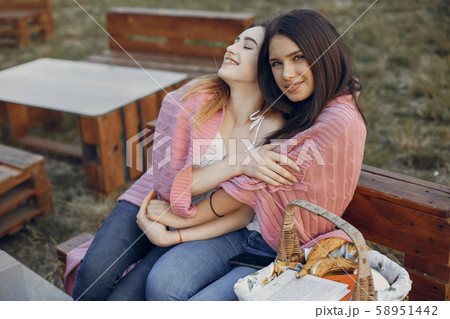 Two pretty girls in a summer park Two pretty girls in a summer park 58951442