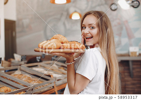 Beautiful girl buys buns at the bakery 58953317
