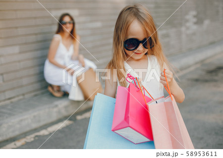 Mother and daughter with shopping bag in a city Mother and daughter with shopping bag in a city 58953611