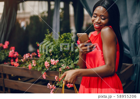 Beautiful black girl with shopping bags in a city 58955206