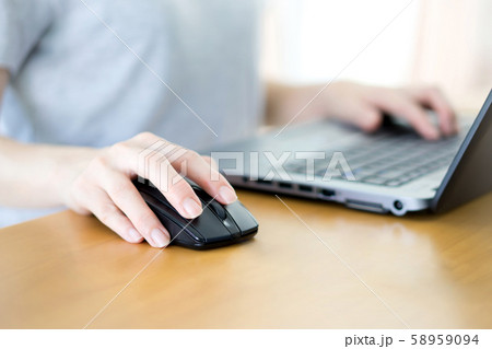 Image of female hands clicking computer mouse 58959094