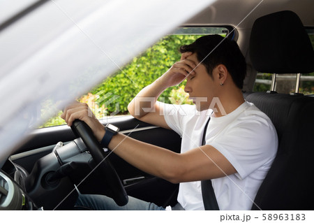 Tired young man sleep in car, Hard work causes 58963183