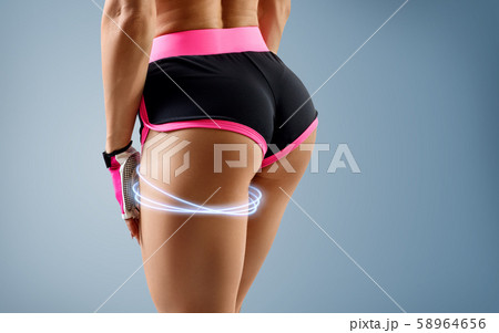 Unrecognizable woman demonstrates her perfect muscular buttocks. 58964656