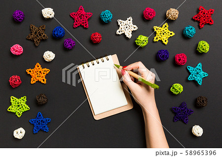 Top view of female hand making some notes in Top view of female hand making some notes in 58965396