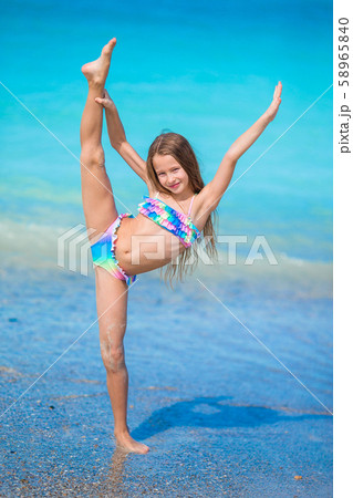 Adorable active little girl at beach during summer vacation 58965840