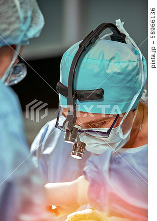 Portrait of a team of surgeons at work. During surgery. Concept medicine, saving lives. Portrait of a team of surgeons at work. During surgery. Concept medicine, saving lives. 58966136