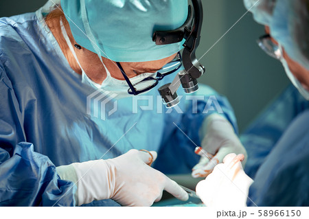 Portrait of a team of surgeons at work. During surgery. Concept medicine, saving lives. Portrait of a team of surgeons at work. During surgery. Concept medicine, saving lives. 58966150
