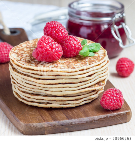 Stack of pancakes or fritters with raspberry  58966263