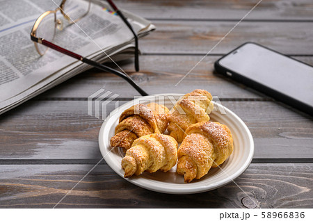 Homemade cookies bagels on wooden background. Near smartphone, newspaper and glasses 58966836