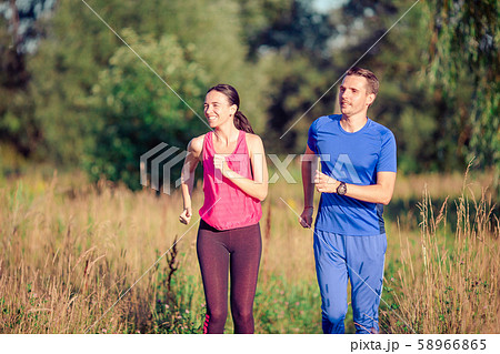 Active sportive couple running in park. Health and fitness. 58966865