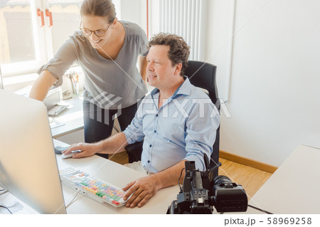 Woman and man working on a video in post-production 58969258